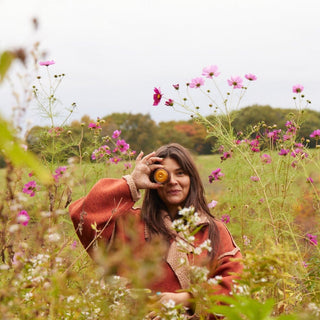Woman in field holding up root vegetable