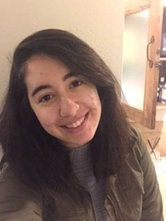 Smiling woman with long dark hair in a jacket
