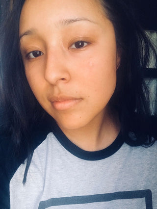 Young woman with dark hair and grey shirt