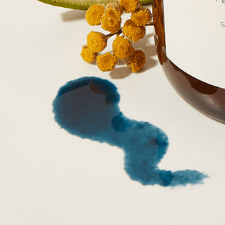 Blue Tansy oil spill with yellow flower