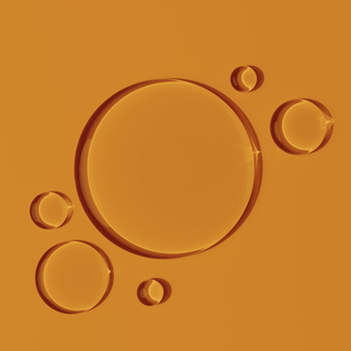 CoQ10 oil drops on orange background