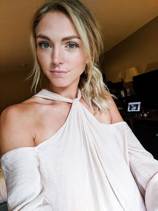 Blonde woman in off-the-shoulder top, selfie