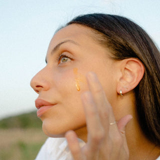 Model Applying Sea Berry Balancing Facial Oil to face for skin barrier repair support