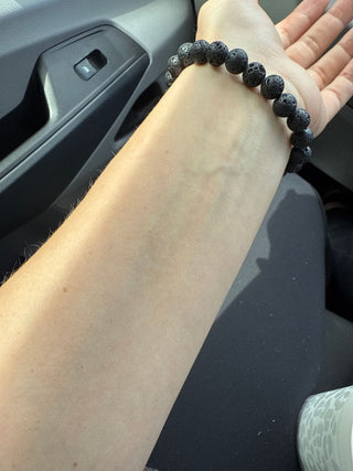 Lava bead bracelet on wrist