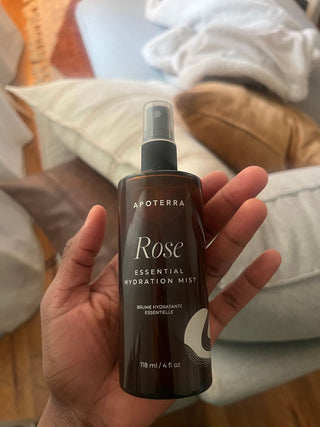 Apoterra Rose Essential Hydration Mist bottle being held in hand 