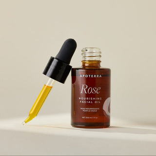 Apoterra Rose Nourishing Facial Oil glass bottle with dropper showing rose oil