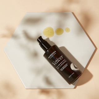 Apoterra Vetiver Illuminating Oil Cleanser with oil texture lifestyle photo