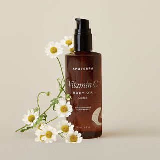 Apoterra Classic Unscented Vitamin C Body Oil for hydration main product image with chamomile flowers