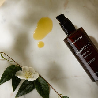 Vitamin C Body Oil With Neroli and Yuzu essential oils with oil texture lifestyle laydown image