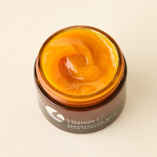 Apoterra Vitamin C Balm image from the top showing deep, rich orange texture