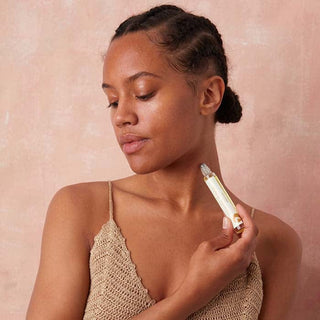 Apoterra beauty tool being used on woman's neck.
